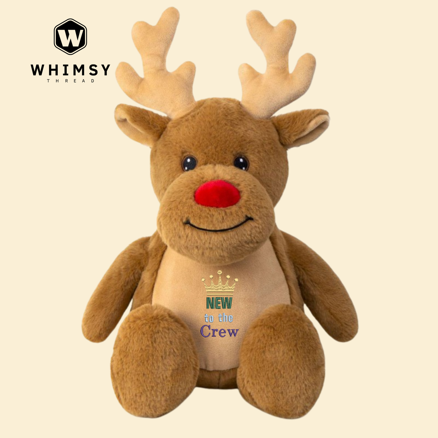 Plush reindeer toy with 'New to the Crew' text on a beige background, branded with Whimsy Threads.
