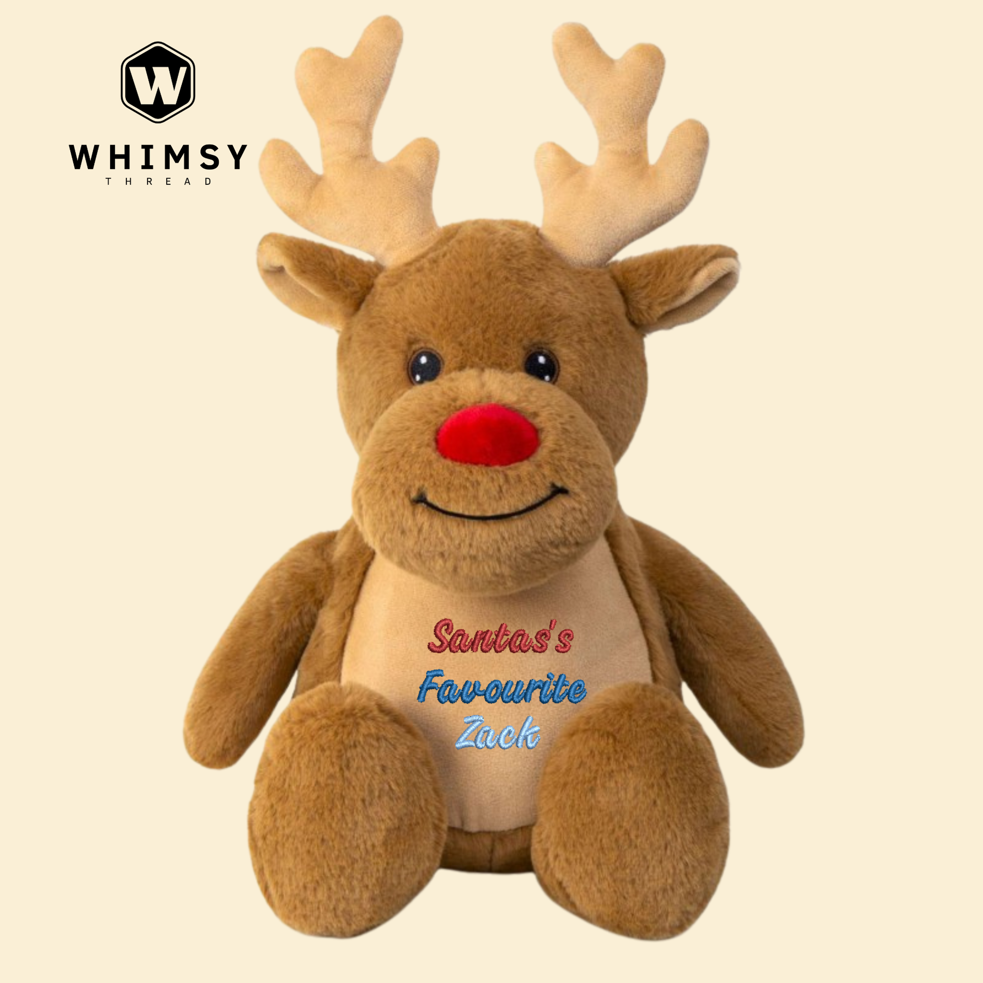 Plush reindeer toy with 'Santa's Favourite' text on a beige background, branded with Whimsy Threads.