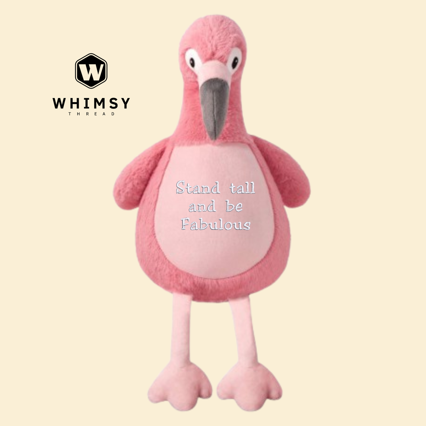 Pink flamingo plush toy with 'Stand tall and be fabulous' text on a beige background, branded with Whimsy Thread.